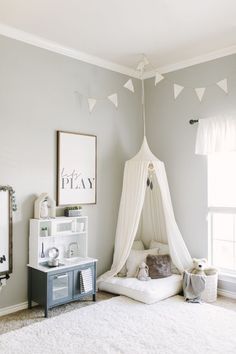 a white bed sitting in a bedroom next to a window