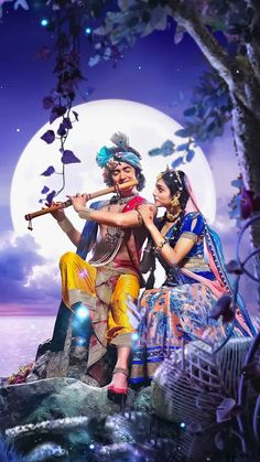 two people sitting on a rock in front of a full moon with an instrument and flute