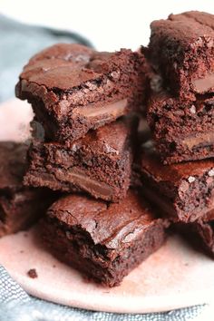 a pile of brownies sitting on top of a white plate