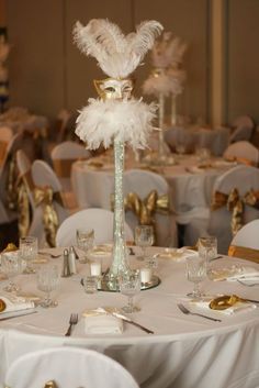 the centerpiece is decorated with white feathers