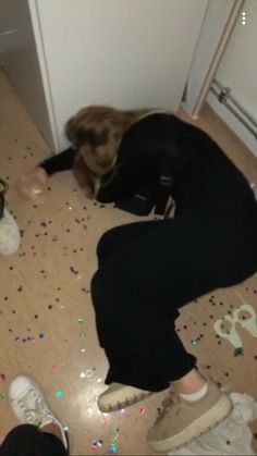 a woman is laying on the floor with confetti all over her