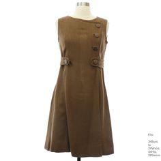 Early 60s "Goldfischer" Womens mocha brown silk linen blend sleeveless mid length mod dress. Semi-scoop neckline, basic bodice, fitted waistline. Soft heavier linen, slightly slubby woven texture, faux wrap style. Princess seams, non-functional buttons on the upper left and an attached belt detail with accent buttons, flared skirt and full silky lining. Zipper back closure. Fits: 34Bust, to 29Waist, 36Hip, 28Sleeve Our item # 390635 Brown A-line Dress With Buttons, Retro Brown Dress With Buttons, Brown Buttoned Dress For Work, Vintage Brown Dress For Work, Vintage Brown Workwear Dress, Basic Bodice, Prom For Guys, Vintage Shirt Dress, Ugly Xmas Sweater