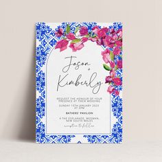 a blue and white wedding card with pink flowers