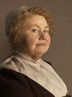 an older woman with curly hair and blue eyes