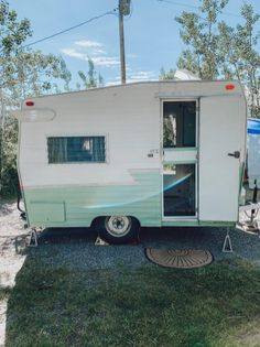 an rv parked in the grass with its door open