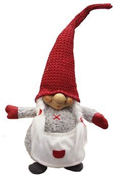 a red and white knitted gnome doll with an apron on it's head