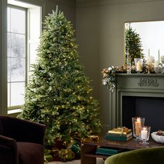 a living room decorated for christmas with a lit tree in the corner and presents on the table