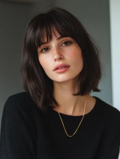 This sleek lob is a perfect example of the 90s trend with its full bangs and sharp lines. The deep brunette color adds richness and depth, making it ideal for those with medium to thick hair. The haircut’s blunt edges sit just above the shoulders, creating a clean, polished look that’s both timeless and modern. The full bangs draw attention to the eyes and soften the face, making it a great choice for those with oval or heart-shaped faces. Heart Face Bob Haircut, A Line Lob With Bangs, Straight Hair Lob, Sleek Lob, Shoulder Haircuts, Thick Hair Bob, 90s Lob, Bangs Thick Hair, Bottleneck Bangs