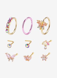 six pairs of rings with different designs and colors on the front, one is gold