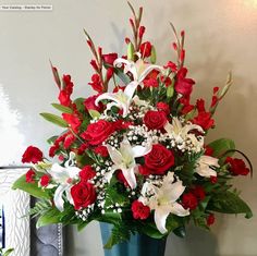 a blue vase filled with red and white flowers