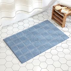 a bathroom with a blue rug on the floor