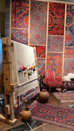 a room filled with lots of colorful rugs and furniture next to a wall mounted tv