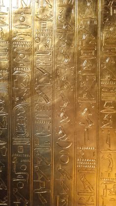 an image of egyptian writing on gold foil