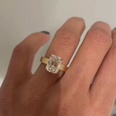 a woman's hand with a ring on it and a diamond in the middle