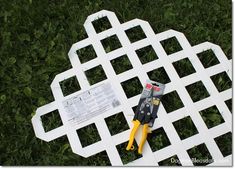 a pair of pliers sitting on top of a white piece of plastic in the grass