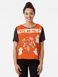 a woman wearing an orange trick or treat t - shirt with ghost and pumpkins on it