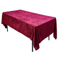 a table with a red cloth on it and black metal legs in front of a white background