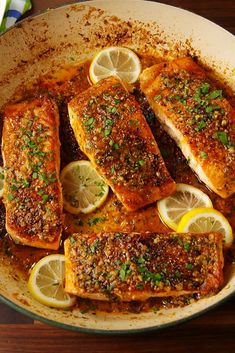 baked fish with lemons and herbs in a pan