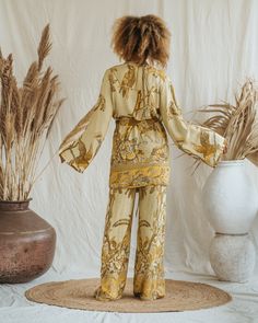 Presenting the Golden Lotus - Short Kimono, a unique piece from our slow fashion collection that's designed to radiate your confidence and individuality. This distinct piece is reversible, displaying meticulous craftsmanship and made-to-order for an opulent appearance that's sure to captivate attention. Size: Our model has the following measurements: Height: 172 cm | 5 ft 7 inches Chest: 88-94 cm | 35-37 inches She is wearing size M kimono with 85 cm | 33 inch length. Chic Rayon Sets For Spring, Spring Long Sleeve Rayon Sets, Relaxed Fit V-neck Kimono For Loungewear, Chic Long Sleeve Kimono For Loungewear, Relaxed Fit Sets For Spring, Chic Flowy Kimono For Loungewear, Flowy Long Sleeve Kimono For Loungewear, Spring Loungewear Tops With Kimono Sleeves, Chic Relax Fit Sleepwear For Vacation