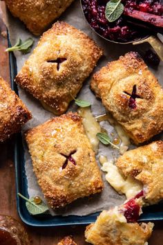 baked pastries with cranberry sauce and fresh mint leaves on the side, ready to be eaten