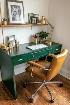 a green desk with a computer and some pictures on the wall above it, along with a leather chair