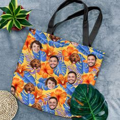 a tote bag with an image of two men and a dog on it next to a potted plant