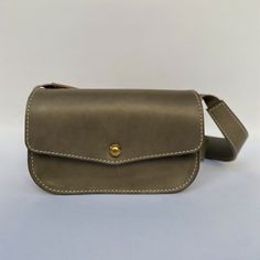 Just like the name claims - a mini version of the newest member of our family. The Mini Field Bag is for the true minimalist. Ready for any adventure, the Mini Field Bag features a brass pull release closure, a nice zipper under the front flap, and a large back pocket and an interior card holder pocket. Dimensions 5" H x 8" W x 2.5" D Strap length 41” adjustable to 43” All our bags are made with American sourced fully vegetable tanned leather. When exposed to sunlight, oils and water, the leathe Classic Rectangular Belt Bag For On-the-go, Classic Smooth Grain Belt Bag, Classic Belt Bag For Daily Use, Classic Travel Belt Bag Satchel, Classic Rectangular Belt Bag For Everyday Use, Classic Everyday Rectangular Belt Bag, Classic Belt Bag With Removable Pouch For Everyday Use, Classic Shoulder Bag With Removable Pouch For Everyday, Classic Shoulder Bag With Detachable Strap For Everyday