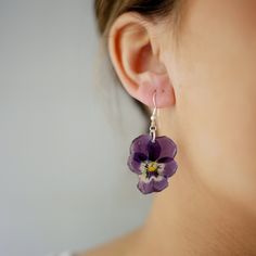 Aren't flowers great? With my handmade jewellery, you can wear your garden or your favourite flower! Every single flower is natural, and no pair of earrings will ever look the same. What you get is completely unique and one of a kind.  Everything in my shop is handmade using real pressed flowers preserved in resin, and all wires/studs are either 925 sterling silver, real gold plated brass or gold plated sterling silver.  Most jewellery is made to order, so if you would want any adjustments made, or have any questions at all, please get in touch. Shipping: Most orders will be shipped out within two working days, look out for a little pink box with your name on it! If ordered as a gift, I will add a handwritten note with your gift message on it. Free delivery within the UK. Free delivery on Purple Flower Nature-inspired Jewelry, Nature-inspired Purple Flower Jewelry, Purple Nature-inspired Flower Jewelry, Handmade Purple Flower-shaped Jewelry, Purple Flower-shaped Jewelry With Handmade Flowers, Purple Flower Jewelry With Handmade Details, Purple Flower Jewelry With Handmade Flowers, Purple Flower-shaped Handmade Jewelry, Purple Flower-shaped Jewelry With Pressed Flowers