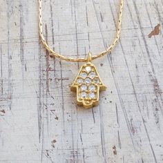 "Hamsa necklace gold Hamsa hand choker Lucky charm necklace Gold filled necklace with a petite 10mm 14k gold filled hamsa pendant with cubic zirconia . The gold hamsa necklace as a symbol of luck. This necklace is perfect for yourself, giving as a special gift, or bridesmaid necklace. Little, simple and Miraculous !! Necklace Measures Approximately 17\" Pendant size 10 mm Item # 20067 Made from 14k gold filled chain & pendant If you would like this chain altered, please convo me. All my jewe Adjustable Gold Plated Pendant Charm Necklace, Adjustable Gold Plated Pendant Charm Necklaces, Dainty Pendant Charm Necklaces For Meditation, Spiritual Gold Plated Necklace For Good Luck, 14k Gold Filled Spiritual Pendant Necklace, 14k Gold-filled Spiritual Charm Necklace With Adjustable Chain, Adjustable 14k Gold Pendant Charm Necklace, Spiritual 14k Gold-filled Charm Necklace With Adjustable Chain, Spiritual 14k Gold Filled Pendant Necklace