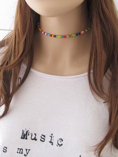 "The Dainty Colorful Beaded choker is great for summer and in the beach. It is made with small Japanese glass beads. This Beaded Choker can be perfect to wear everyday. This listing for one choker. Three color versions of the choker are available. Primary photo shows the choker version 1. DETAILS - Japanese glass seed beads 4 mm - Quality strong nylon string - Choker length. Choose in the drop down menu - Lobster or round clasp closure. Available gold tone (default) or silver tone (by request) - Colorful Choker, Handmade Choker Necklace, Festival Necklace, Handmade Chokers, Beach Necklace, Dainty Choker, Bead Choker, Beach Necklaces, Boho Choker