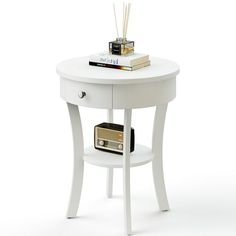 a white table with a radio on it and some books sitting on top of it