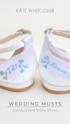 a pair of white shoes with blue flowers on them