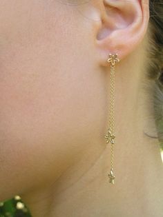 14k gold dangle flowers earrings. Beautiful, sweet and dainty solid gold earrings, with delicate flowers dangling from gold chains. App. 7 cm long. Made of 14k gold with a shiny finish. Also available, gold flower studs, here: http://www.etsy.com/listing/74272111/ A matching necklace: https://www.etsy.com/listing/487540199 To get back to my shop click here: http://www.etsy.com/shop/DaliaShamirJewelry?ref=si_shop Long Chain Earrings Gold, Beautiful Diamond Earrings, Gold Flower Earrings, Unique Gold Jewelry Designs, Bridal Chura, Dainty Gold Earrings, Gold Chain Earrings, Long Chain Earrings, Flowers Earrings