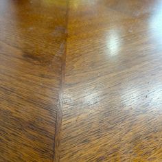 a close up view of a wooden table with scratches on the top and bottom surface