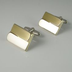 A unique pair of mid century fine sterling silver gold plated accent one of a kind cufflinks circa 1950.These classic 1950s cufflinks have gold plated accents and a unique design which catches the light from every angle.The front of the cufflinks is plated in gold and the backs and cuff link fittings are silver.The design is quite timeless.Together they weigh 14.33 grams.They are each clearly marked on the cuff link fittings 835 for fine European silver.Each of the classic design cufflink faces Luxury Rectangular Cufflinks For Anniversary, Classic Rectangular Wedding Cufflinks, Gold Rectangular Cufflinks For Anniversary, Classic Gold Rectangular Cufflinks, Classic Rectangular Cufflinks For Anniversary, Modernist Cuff Jewelry For Gift, Vintage Rectangular Cufflinks For Gifts, Modernist Rectangular Jewelry For Formal Occasions, Rectangular Polished Cufflinks For Formal Wear