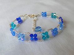 a bracelet with blue and green flowers on it