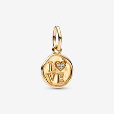 A golden gift for the one who's left their stamp on your heart. The Sparkling Love Stamp Dangle Charm is crafted in 14k solid gold and features an organically shaped round disc with slightly raised edges, resembling an old-fashioned wax seal on a letter. At the center are raised letters spelling "L♥VE", with three stones set into a heart shape in place of the "O". Carry a message of love wherever you go when you wear it on your favorite Pandora jewelry or charm holder. Pandora Sparkling Love Sta Pandora Wishlist, Rabbit Charm, Diy Jewelry Gifts, Heart Padlocks, Raised Letters, Charm Holder, Love Stamps, Pandora Bracelet Charms