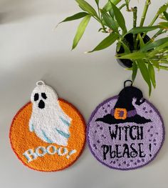 two halloween ornament hanging from a plant