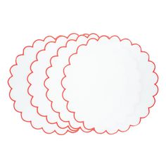 four white placemats with red scalloped edges