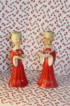 two red and white figurines are standing next to each other