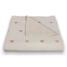 a white blanket with pink hearts on it