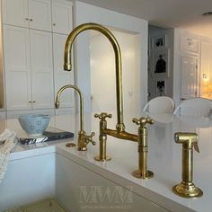 a kitchen sink with two faucets and a bowl on the counter