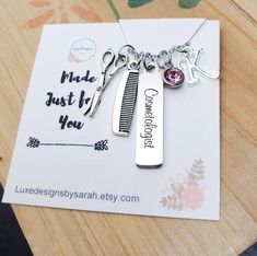 a personalized necklace with two charms on top of a piece of paper that says made just for you