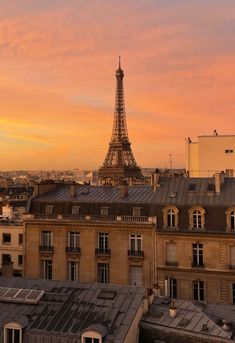 the eiffel tower towering over paris at sunset