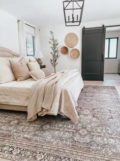 a bedroom with a bed, rug and lamp