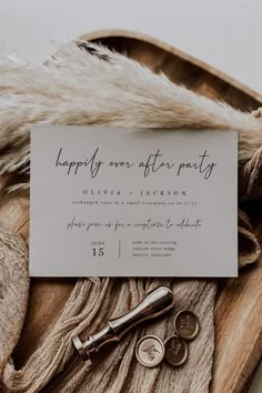 the wedding stationery is laid out on top of a fur - lined blanket and some keys