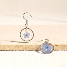 🌸These exquisite 925 Sterling Silver Forget Me Not Flower Earrings are the perfect accessory to add a touch of natural beauty to any outfit. Handmade with love and care, each earring features real pressed forget-me-not flowers encased in a clear resin, preserving their delicate petals for years to come. The dangle drop design adds an elegant and feminine touch, making them an ideal Valentine's Day gift for that special someone. Pressed Flower Earrings, Forget Me Not Flower, Drop Design, Valentines Day Gifts For Her, 925 Silver Earrings, Women's Casual Style, Silver Accessories, Clear Resin, Stunning Earrings