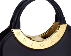 BVLGARI Roma Small Top Handle Bag In Black Metropolitan Calf Leather With Black Nappa Leather Lining. Iconic Metal Detail In Antique Gold-plated Brass Engraved With The BVLGARI Logo, And Press Button Closure. Bvlgari Logo, Small Top Handle Bag, Metal Detail, Natural Latex, Handle Bag, Make A Wish, Nappa Leather, Small Tops, Leather Handle