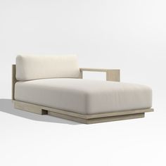 a white couch sitting on top of a wooden frame