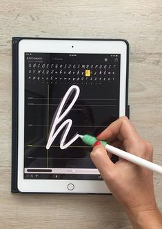 a person writing on an ipad with a marker